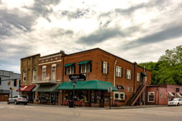 [Photo: A street corner with three businesses, in brick buildings, in Loudon, Tennessee.]