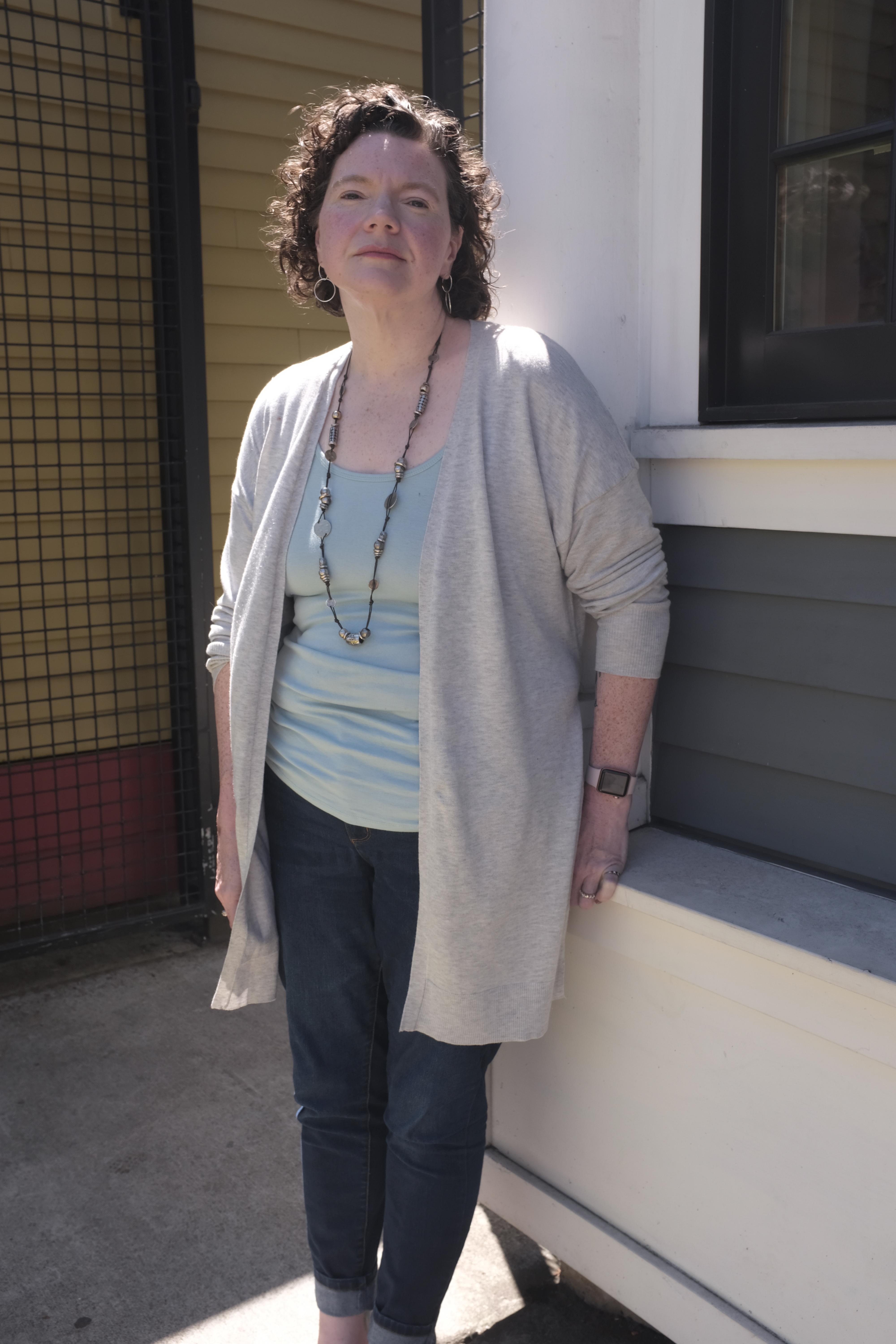 Photo: Meghan Eagen-Torkko, who sought miscarriage care at a Catholic hospital, stands in front of a wall.